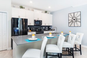 Enjoy meals at the central island with a microwave and sleek refrigerator.