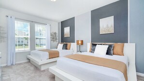 A modern bedroom with two beds, a large window, and artwork on the walls. - Last Minute Disney! Private Pool, Hot Tub & Themed Bedrooms. Book Now! #49467 (Orlando)