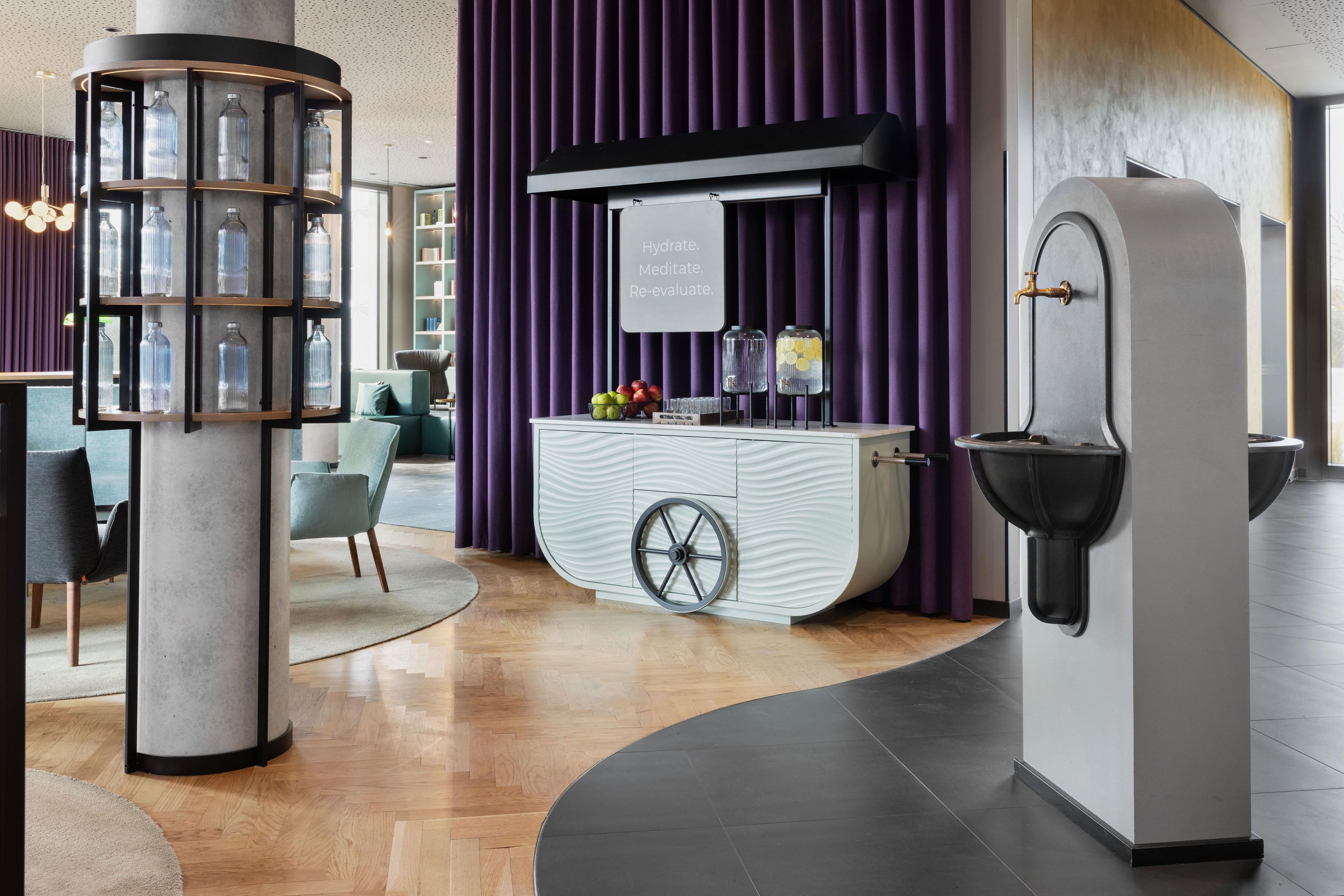 A modern bar area with a unique ice dispenser and a display of bottles.
