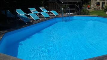 Seasonal outdoor pool, open 9:30 AM to 7:30 PM, pool loungers