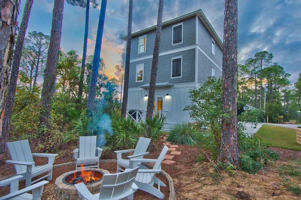 A two-story building with a fire pit and outdoor seating.