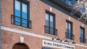 A two-story brick building with a storefront labeled "King Street Commons."