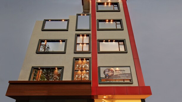 A hotel with multiple windows, a sign advertising "Hotel Villa Inn Premium AC Rooms," and a modern architectural design. - Treebo Villa Inn Aurangabad (Chhatrapati Sambhajinagar)