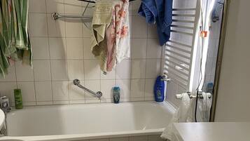 Bathtub, hair dryer, towels, soap