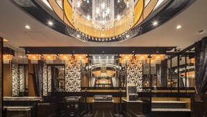 A luxurious lobby with a grand chandelier, mirrored walls, and a check-in counter. - APA Hotel Ueno Ekiminami (Tokyo)