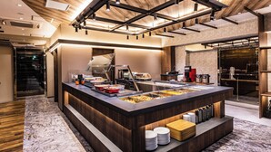 A modern kitchen with a central island, built-in appliances, and a wooden ceiling. - APA Hotel & Resort Osaka Umeda Eki Tower (Osaka)