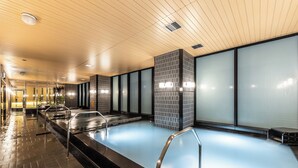 A modern indoor swimming pool with a tiled wall and a wooden ceiling. - APA Hotel & Resort Osaka Umeda Eki Tower (Osaka)