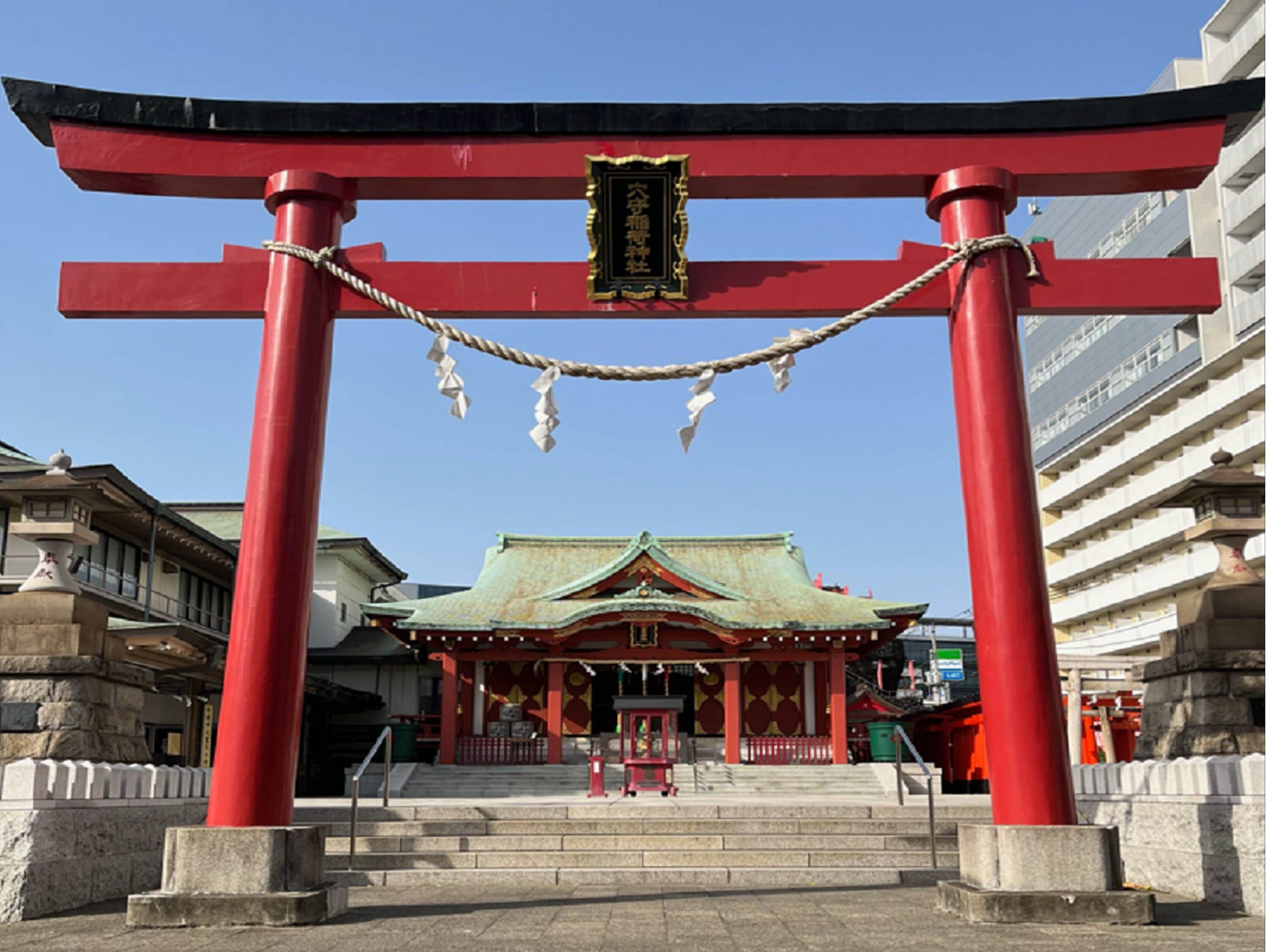 A traditional Japanese torii gate with a shrine in the background.