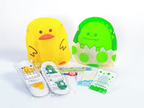 Two plush toys, one yellow and one green, with accompanying packaged items. - APA Hotel Asakusabashi Ekimae (Tokyo)