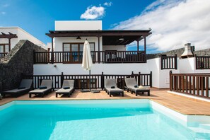 A heated pool, pool loungers