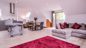 A modern loft apartment with a dining area, kitchen, and living room. - The Barn at Mulberry Lodge (Maidstone)