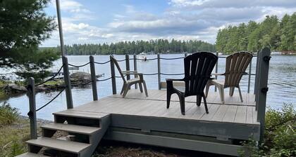 Cozy Sebec Lake front cabin with dock and fire pit
