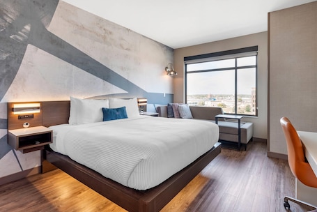 Premium bedding, down comforters, desk, laptop workspace. Cambria Hotel Minneapolis Downtown