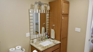 A bathroom with a sink, mirror, towel rack, and toilet paper. - Travel light long-term (safe & relaxing )special discount for travel nurse (Veazie)