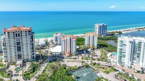 A high-rise hotel complex with multiple buildings, a central courtyard, and a view of the ocean. - Bright, airy Gulf of Mexico views! - WS1101 (Naples)