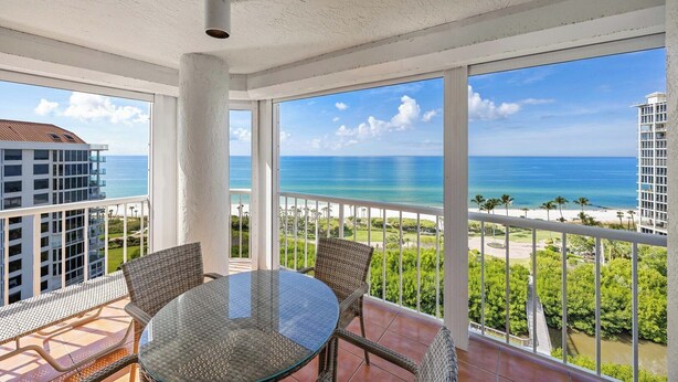 A balcony with a glass table and wicker chairs, overlooking a beach and ocean. - Bright, airy Gulf of Mexico views! - WS1101 (Naples)