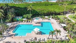 A resort pool area with multiple swimming pools, sun loungers, and palm trees. - Bright, airy Gulf of Mexico views! - WS1101 (Naples)
