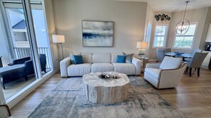 A modern living room with a sofa, armchairs, a coffee table, and a dining area. - Beautiful 3-bedroom condo walking distance to the beach - Reg 4-PH4 (Naples)