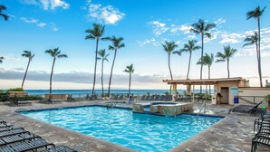 A swimming pool with lounge chairs and palm trees, overlooking the ocean. - Sugar Beach Resort PH 14 Penthouse unit, Oceanfront complex, Ocean View, A/C (Kihei)