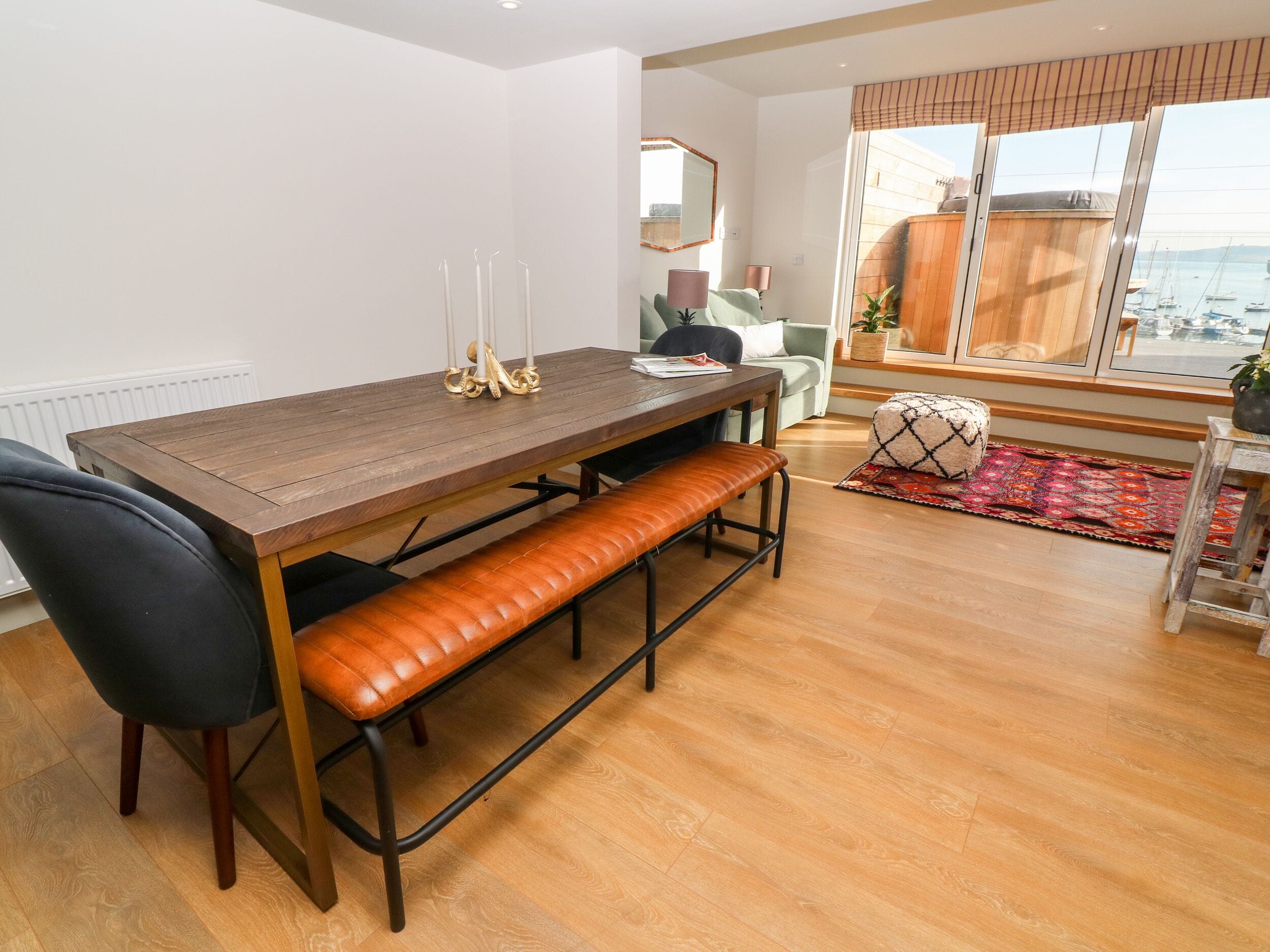 A dining area with a wooden table, bench, and chairs.