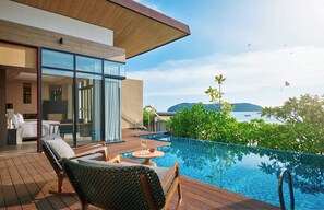 A modern hotel room with a large glass window, a wooden deck, and a pool. - PARKROYAL Langkawi Resort (Langkawi)