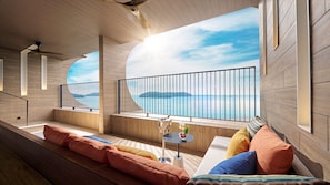 A modern interior with a curved wall and a balcony overlooking a body of water. - PARKROYAL Langkawi Resort (Langkawi)