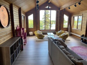 Relax in this serene space with a comfortable sofa, two bean bag chairs, and a fireplace.