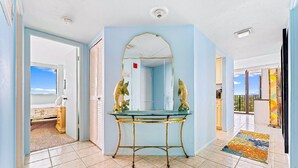 A room with a glass-top vanity, a large mirror, and two decorative fish sculptures. - Lovely 2 Bedroom/ 2 Bath Across Siesta Key Beach! (Siesta Key)