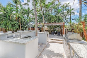 Enjoy al fresco dining in a serene, atmosphere surrounded by lush tropical plants and palm trees.