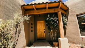 A stucco building with a wooden door and a covered entrance. - Luxury West Sedona home close to everything (Sedona)