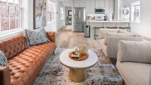 A modern kitchen with white cabinets, stainless steel appliances, and a central island. - ★1/2 Block to King Street, King Bed ~ Free Parking★ (Alexandria)