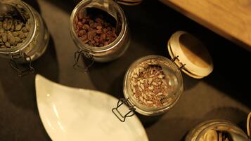A variety of glass jars with metal lids containing different food items, arranged on a table.