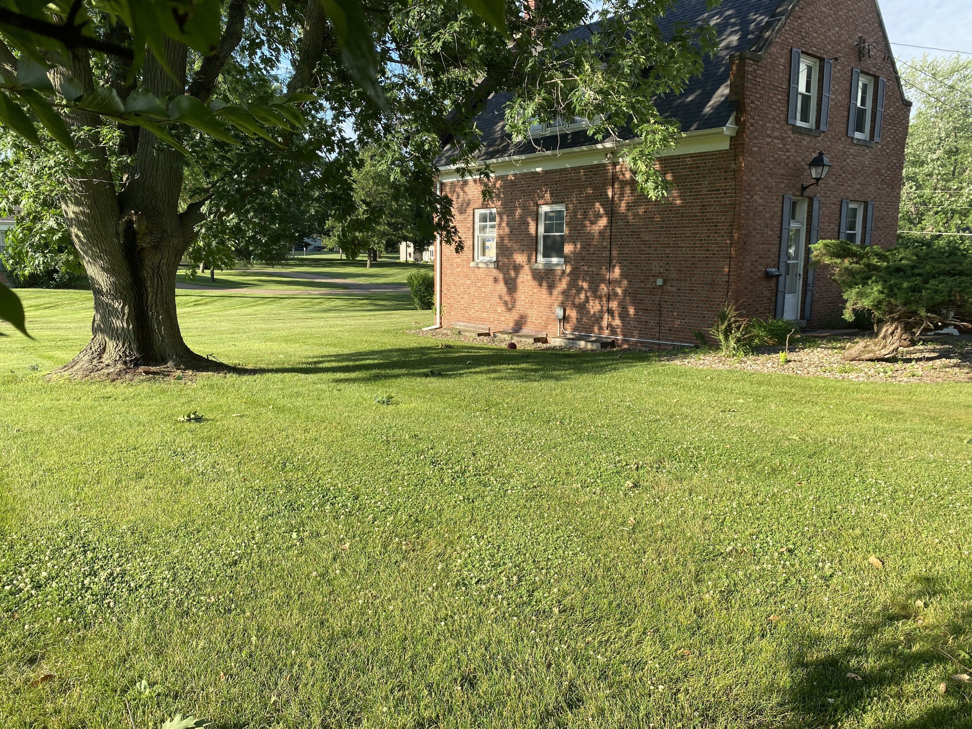 A brick building with a small lawn in front.