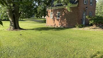 A brick building with a small lawn in front.