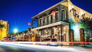 A historic building with a bar and tobacco sign, featuring classic architecture and a prominent mural.