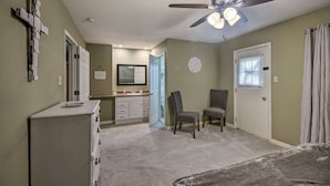 A bedroom with a bed, a ceiling fan, a dresser, a chair, and a window. - Peaceful Home, Colleges-Hospitals-Shops Close, Corporate Bookings Welcome  (Jackson)