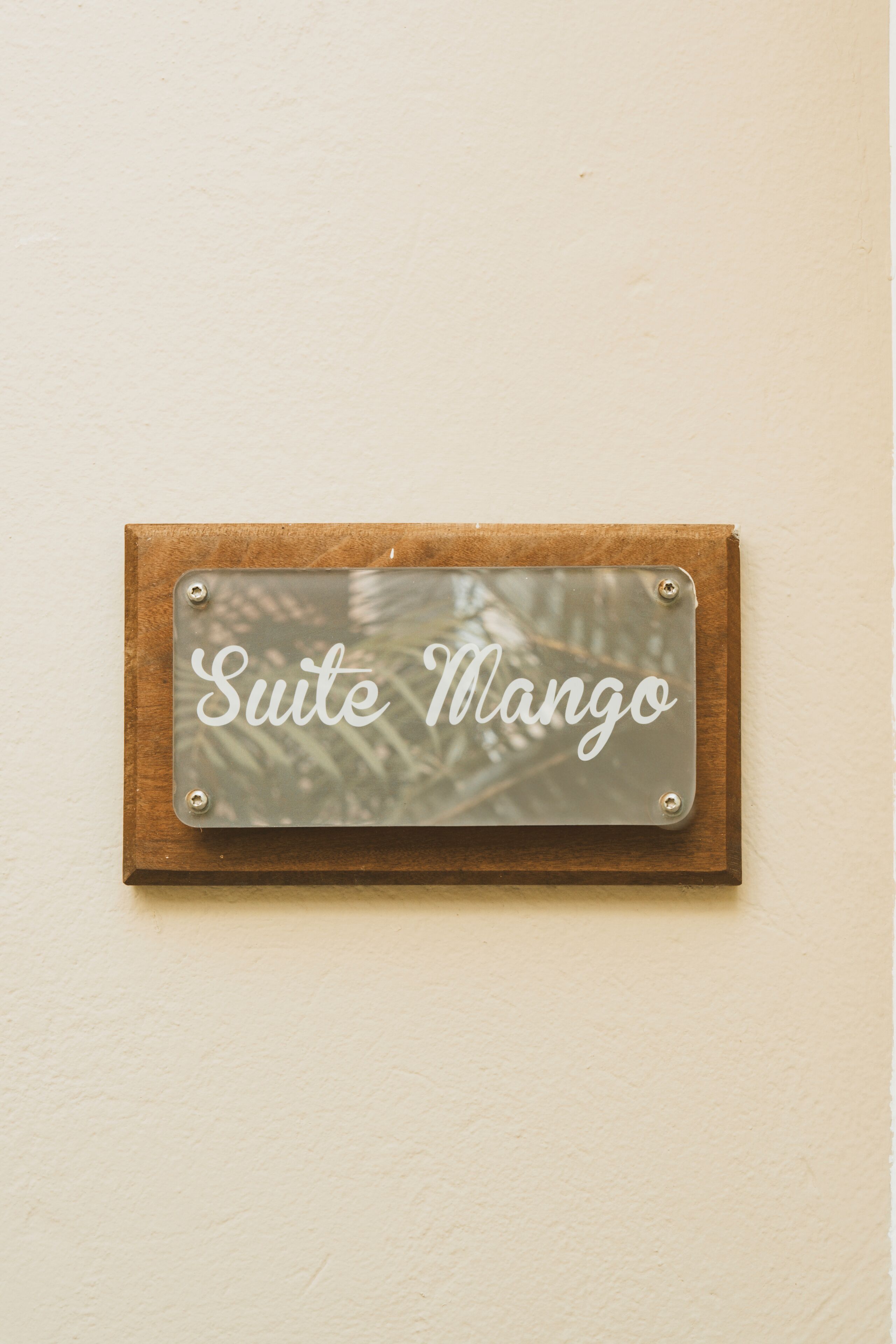 Un letrero con el texto 'Suite Mango' montado en una pared.