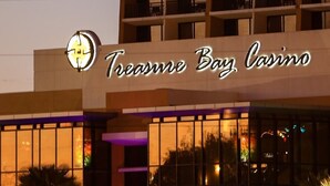 A building with a sign reading "Treasure Bay Casino".