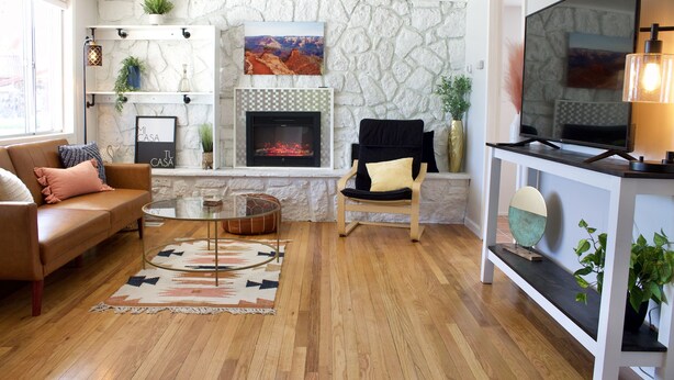 A living room with a stone fireplace, a sofa, a coffee table, and a TV. - Casa Little Bird (Los Alamos)