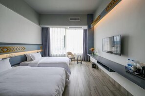 A hotel room with two beds, a TV, a small table, and a window with curtains. - Bengenei Hotel (Qiongzhong)