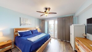 A bedroom with a bed, a ceiling fan, a nightstand, a dresser, and a TV.