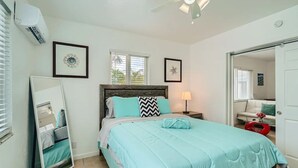 A bedroom with a bed, a nightstand, a mirror, and a ceiling fan. - 🏖🏖 Breathtaking 1 Bedroom ~ Prime Singer Island 🏖🏖 (West Palm Beach)