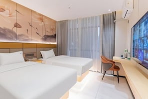 A hotel room with two beds, a desk, a chair, a large TV, and a painting on the wall. - Huizhou galston hotel (Huizhou)