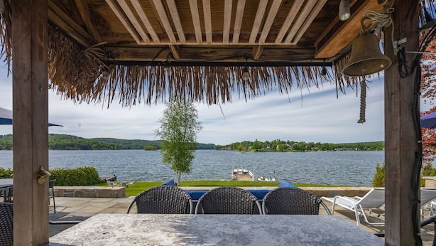 A covered outdoor seating area with a view of a lake and hills. - Candlewood Lakefront 3bd/ 2 bath house w/ 180 degree views! (Danbury)