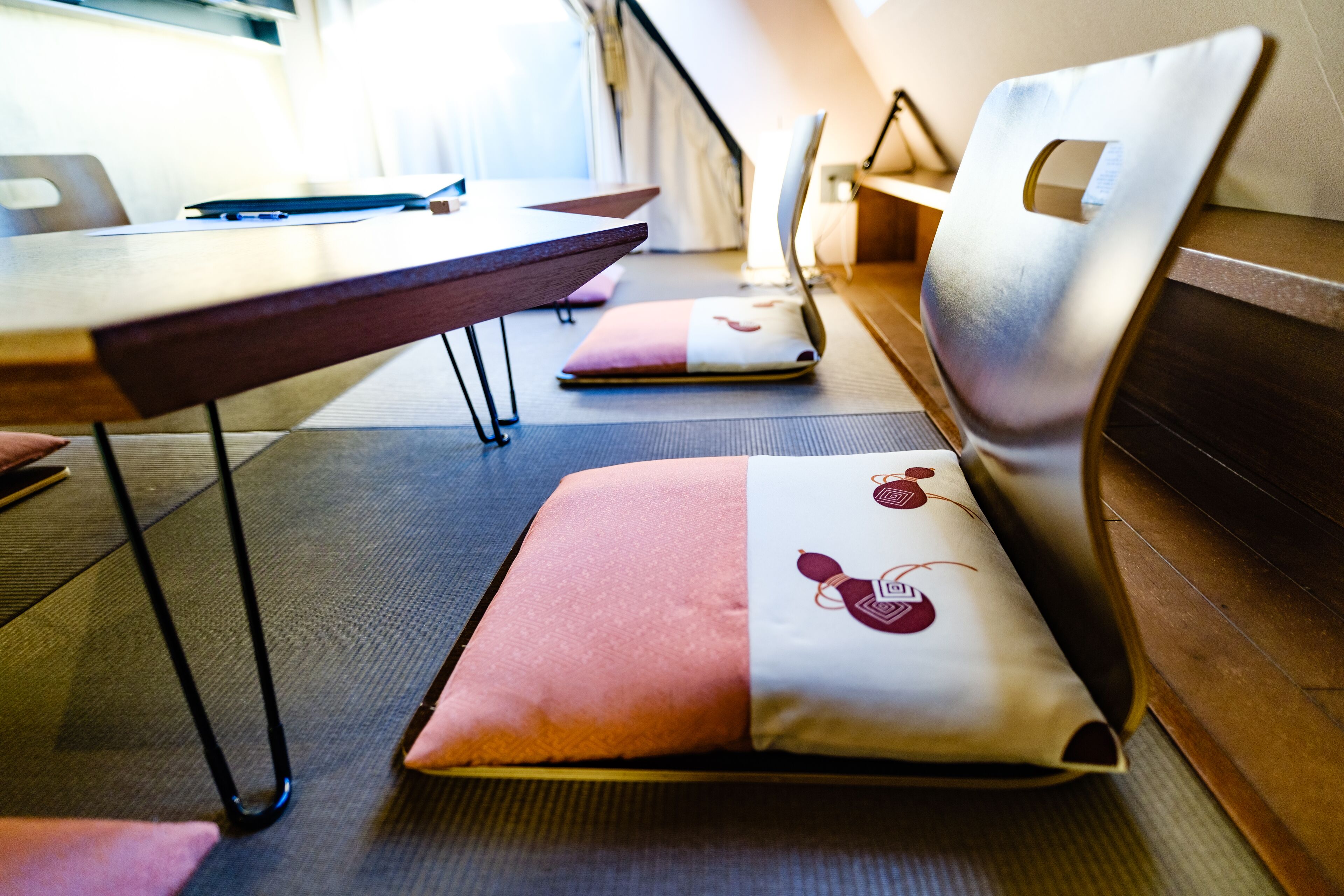 A seating area with cushioned benches and a table, suggesting a dining or meeting space.