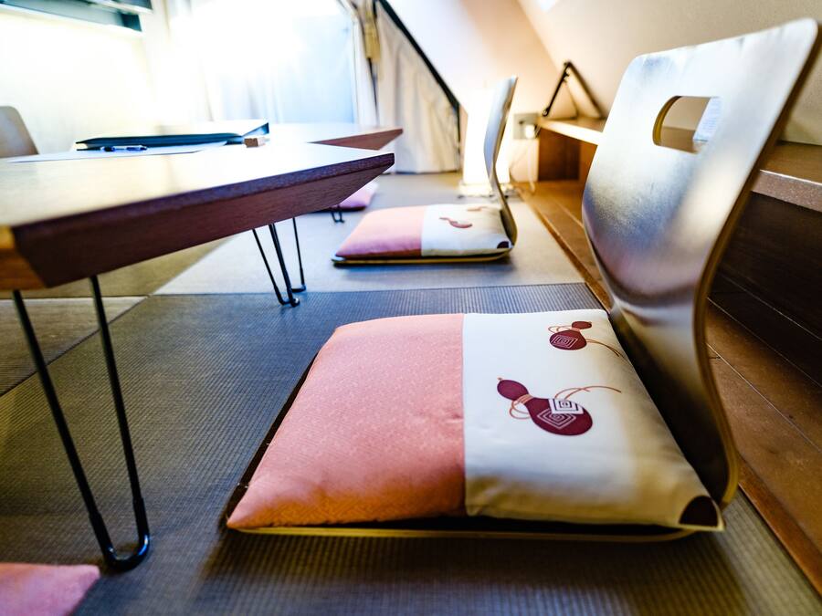A seating area with cushioned benches and a table, suggesting a dining or meeting space.