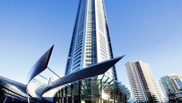 A tall, modern skyscraper with a sleek, pointed top and reflective glass facade. - Sky Point Tower - Private Apartments (Surfers Paradise)