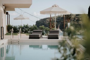 Outdoor pool, open 9:00 AM to 7:00 PM, pool umbrellas, pool loungers