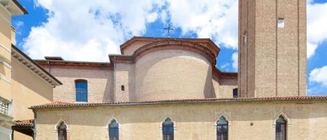 A historic building with a prominent tower and arched windows.