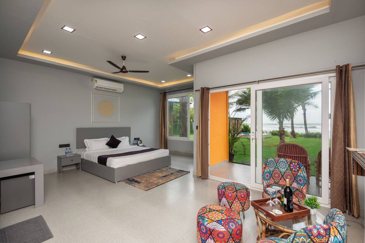 A modern bedroom with a bed, bedside table, and a view of the outdoors.
